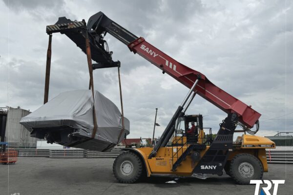 Boat and yacht transport — shrink-wrapped boat lifted by reach stacker at Port Newark