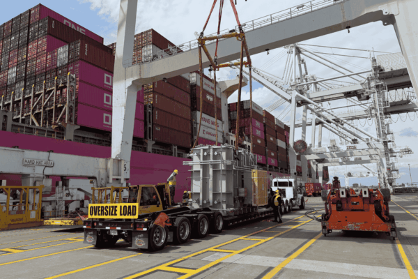 Open top container loading — oversize transformer load under a port gantry crane