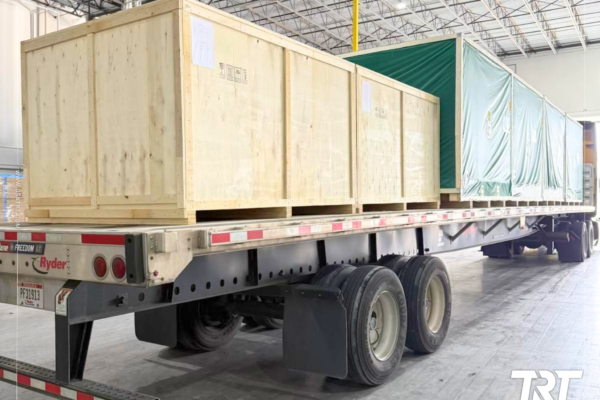 Flat rack lashing — wooden crates secured on a flatbed trailer
